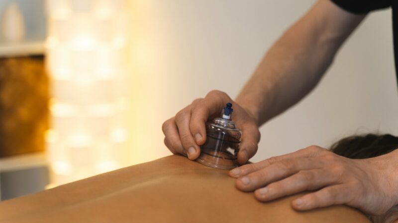 Cupping therapy is being performed on someone's back.